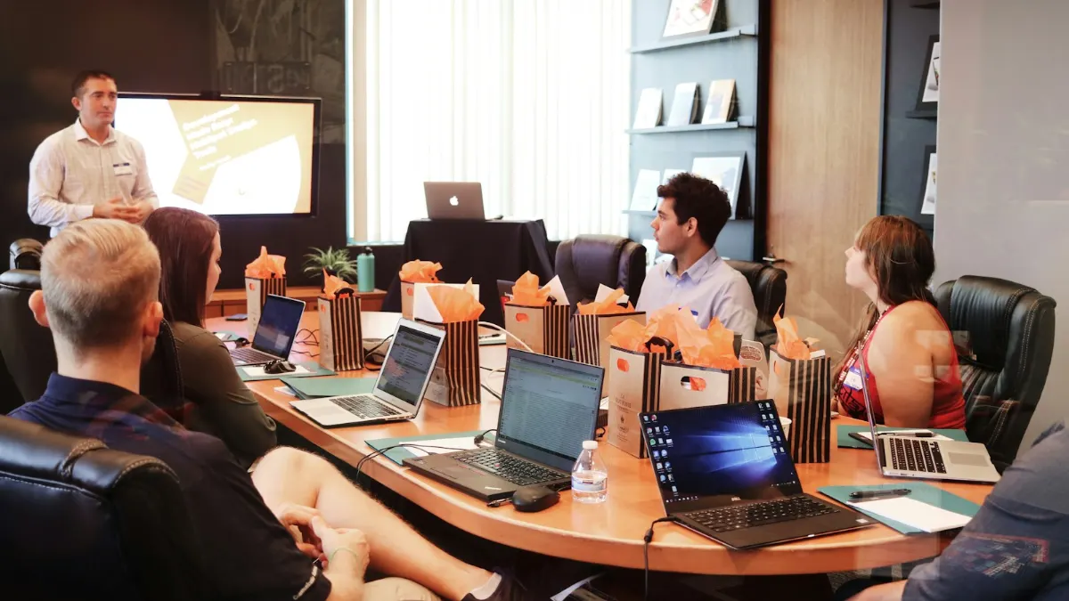 Presenter in front of a team with laptops